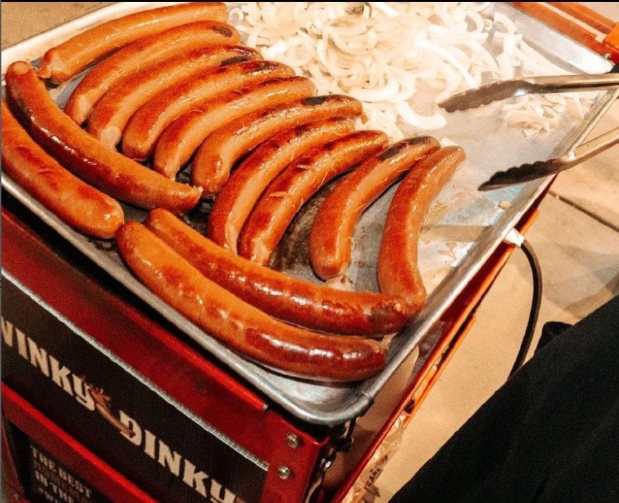 Branded Winky Dinky Dogs grill cart loaded with sausages